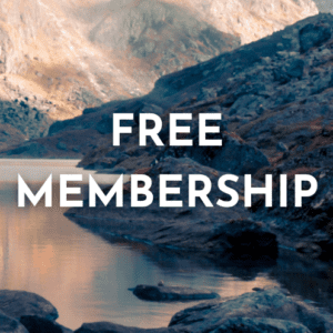 Text "Free Membership" overlaid on an image of a serene mountainous landscape with a calm lake.
